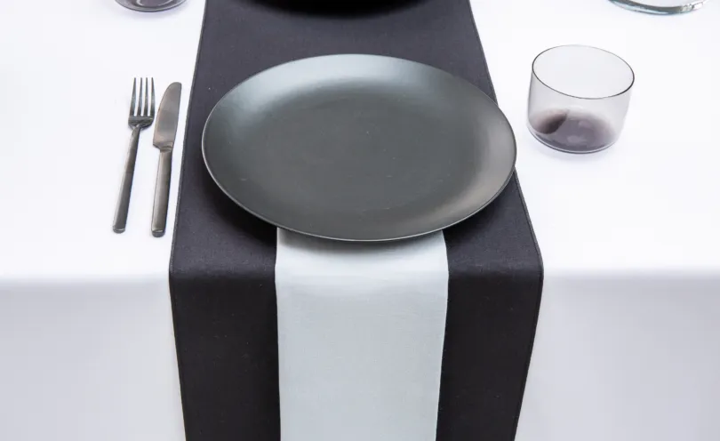 Pebble Grey napkin with Jet Black table runners and Arctic White table cloths