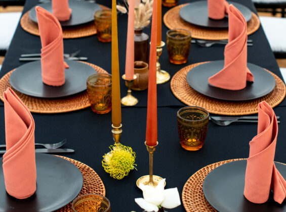 Four Autumn Orange napkins on a Jet Black table cloth base