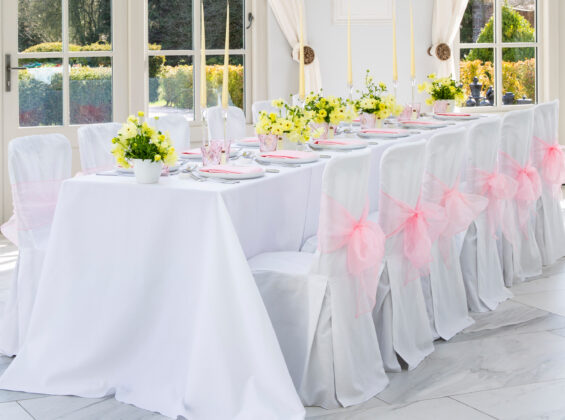 Blossom Pink napkins and organzas with Arctic White table cloths and chair covers