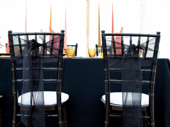 Jet Black organza sashes with Jet Black table cloths and Autumn Orange Napkins