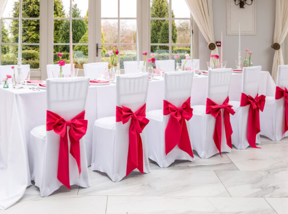 Arctic White tablecloths and stretch chair cover with Pink Fuchsia napkins and chair sashes