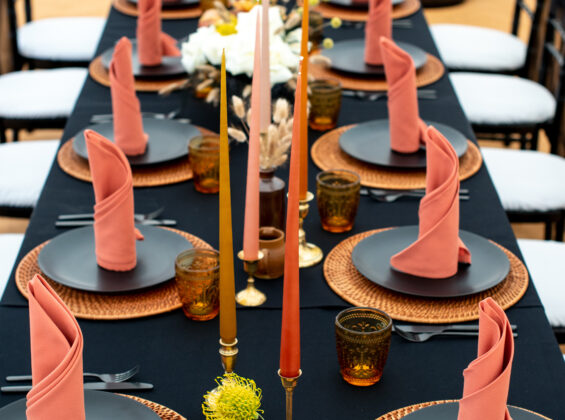 Twelve Autumn Orange napkins on a Jet Black table cloth base