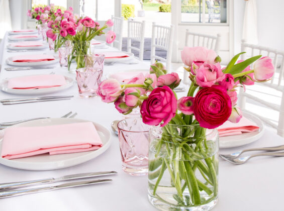 Twelve Blossom Pink napkins with Arctic White table cloths