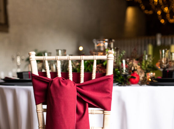 Merlot Red Chair Sashes and Napkins with Arctic White as a base cloth colour