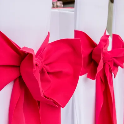 Pink Fuchsia chair sashes and bows with Arctic White stretch chair covers